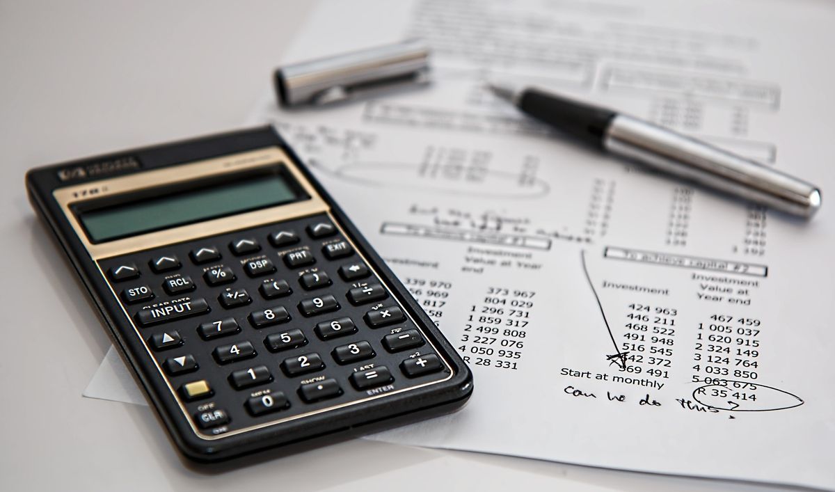 Calculator and pen on port cost documents