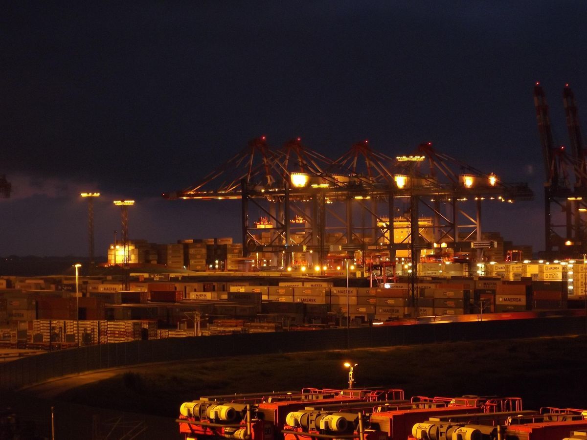 Container terminal cranes lit at night